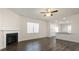 Open-concept living room with hardwood-style floors, fireplace, and view into the kitchen at 132 Paper Birch Way, Fuquay Varina, NC 27526