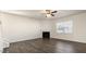 Spacious living room with hardwood-style floors, a ceiling fan, and a cozy fireplace at 132 Paper Birch Way, Fuquay Varina, NC 27526