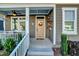 Inviting front porch featuring a stylish front door and decorative accents at 135 Village Walk Dr, Clayton, NC 27527