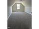 Finished attic area with carpeted floor and natural light from a window at 143 Prency Ln, Middlesex, NC 27557