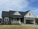 Charming new construction home featuring stone accents and a welcoming front porch at 143 Prency Ln, Middlesex, NC 27557