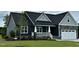 Charming single Gathering home with a white garage door, lovely front porch, and well-manicured front lawn at 143 Prency Ln, Middlesex, NC 27557
