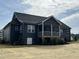 Rear exterior view of a modern home, highlighting the back porch and landscaping at 143 Prency Ln, Middlesex, NC 27557