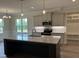 Bright kitchen with an island, stainless steel appliances, and ample cabinet space at 143 Prency Ln, Middlesex, NC 27557