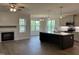 Open-concept living room with a fireplace, and island with stainless steel appliances at 143 Prency Ln, Middlesex, NC 27557
