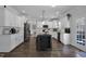 Modern white kitchen with stainless steel appliances, a functional island, and lots of natural light at 149 Minter School Rd, Sanford, NC 27332