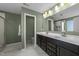Bathroom featuring double sink vanity, hard surface flooring, and a glass door shower at 158 Arlie Ln, Lillington, NC 27546