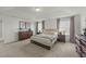 Bedroom featuring a tray ceiling, carpet flooring, and two dressers with matching nightstands at 158 Arlie Ln, Lillington, NC 27546