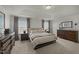 Spacious bedroom featuring a tray ceiling, carpet flooring, and two dressers with matching nightstands at 158 Arlie Ln, Lillington, NC 27546