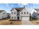 Charming two-story home with neutral siding, well-kept lawn, and attached two car garage at 158 Arlie Ln, Lillington, NC 27546