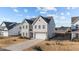 Charming two-story home with neutral siding, well-kept lawn, and attached two car garage at 158 Arlie Ln, Lillington, NC 27546