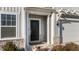 A charming black front door highlighted by stone accents and a pergola above the two car garage at 158 Arlie Ln, Lillington, NC 27546
