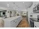 Open-concept kitchen featuring white cabinets and a large island with pendant lighting at 158 Arlie Ln, Lillington, NC 27546