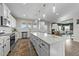 Large kitchen island featuring white cabinets and a view into the adjacent living room at 158 Arlie Ln, Lillington, NC 27546