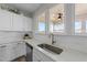 Kitchen featuring stainless steel appliances, a white backsplash, and modern fixtures at 158 Arlie Ln, Lillington, NC 27546
