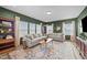 Cozy living room featuring two sofas, a patterned rug, and ample natural light from the windows at 158 Arlie Ln, Lillington, NC 27546