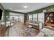 Living room with a view into the kitchen, two sofas and large windows that fill the room with natural light at 158 Arlie Ln, Lillington, NC 27546