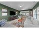 Comfortable living room with green walls, and view into the kitchen at 158 Arlie Ln, Lillington, NC 27546