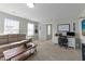 Comfortable living room featuring a couch, desk and guitar on the wall at 158 Arlie Ln, Lillington, NC 27546