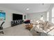 Spacious living room featuring a large sectional couch and entertainment center at 158 Arlie Ln, Lillington, NC 27546