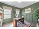A well-lit office space featuring an olive painted walls, modern desk, and two windows at 158 Arlie Ln, Lillington, NC 27546