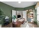 A well-lit office space featuring an olive painted walls, modern desk, and plenty of sunlight at 158 Arlie Ln, Lillington, NC 27546