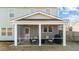 View of the screened-in porch featuring seating and outdoor grill at 158 Arlie Ln, Lillington, NC 27546