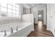 Bright bathroom features a soaking tub with tile surround and a large window at 170 Dunvegan Ln, Burlington, NC 27215