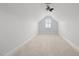 A spacious bonus room with natural light, neutral paint, plush carpet, and a modern ceiling fan at 170 Dunvegan Ln, Burlington, NC 27215