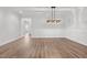 Large, open dining room with hardwood floors and views into the adjoining rooms at 170 Dunvegan Ln, Burlington, NC 27215