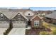 Beautiful home with a stone and brick exterior, complemented by a well-manicured lawn and landscaping at 170 Dunvegan Ln, Burlington, NC 27215