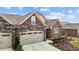 Well-maintained stone and brick home with a lovely lawn, beautiful landscaping, and attached two car garage at 170 Dunvegan Ln, Burlington, NC 27215