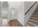 Bright foyer with hardwood floors, white wainscoting, and a staircase leading to the upper level at 170 Dunvegan Ln, Burlington, NC 27215