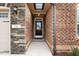 Close-up of the front door with stone and brick architecture and a well-lit entrance at 170 Dunvegan Ln, Burlington, NC 27215