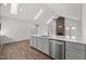 Spacious kitchen with stone fireplace, stainless steel dishwasher, sink, and white cabinets at 170 Dunvegan Ln, Burlington, NC 27215