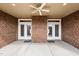 Spacious covered patio made with red brick, concrete floor, and double glass doors ideal for outdoor relaxation at 170 Dunvegan Ln, Burlington, NC 27215