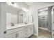 Bathroom with double vanity, white cabinets, and walk-in shower behind a glass door at 1727 Pinecliff Ct, Fuquay Varina, NC 27526