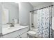 Bathroom showcasing a single sink vanity, toilet, and bathtub with shower curtain at 1727 Pinecliff Ct, Fuquay Varina, NC 27526