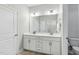 Bright bathroom featuring a double vanity with white cabinets and light countertops at 1727 Pinecliff Ct, Fuquay Varina, NC 27526