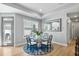 Dining area with a round glass table, patterned rug, and natural light at 1727 Pinecliff Ct, Fuquay Varina, NC 27526
