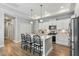 Bright kitchen with a center island, white cabinets, stainless steel appliances, and pendant lighting at 1727 Pinecliff Ct, Fuquay Varina, NC 27526