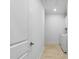 View of the hallway leading to a laundry room with white washer and dryer set, and tiled floor at 1727 Pinecliff Ct, Fuquay Varina, NC 27526