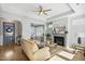 Living room with fireplace, arched entry, big windows, tray ceiling and light wood floors at 1727 Pinecliff Ct, Fuquay Varina, NC 27526