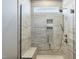 Bathroom showing tiled shower with built-in bench, shower head and frosted glass at 1727 Pinecliff Ct, Fuquay Varina, NC 27526