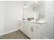 Bathroom with double vanity, white cabinets, modern fixtures, quartz countertop, and tiled floor at 1981 Rosedale Ridge Ave, Wake Forest, NC 27587
