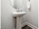 Clean pedestal sink with modern faucet and wood-look flooring at 1981 Rosedale Ridge Ave, Wake Forest, NC 27587