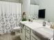 Bathroom features a double vanity, decorative mirror, and white cabinets at 1981 Rosedale Ridge Ave, Wake Forest, NC 27587