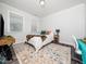 Cozy bedroom with natural light, neutral tones, wood-look flooring and a patterned rug at 1981 Rosedale Ridge Ave, Wake Forest, NC 27587