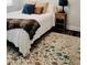 Comfortable bedroom featuring decorative pillows and a patterned rug adding warmth and style at 1981 Rosedale Ridge Ave, Wake Forest, NC 27587