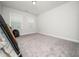 Bedroom with neutral carpet, two windows with blinds, and furniture for moving in at 1981 Rosedale Ridge Ave, Wake Forest, NC 27587